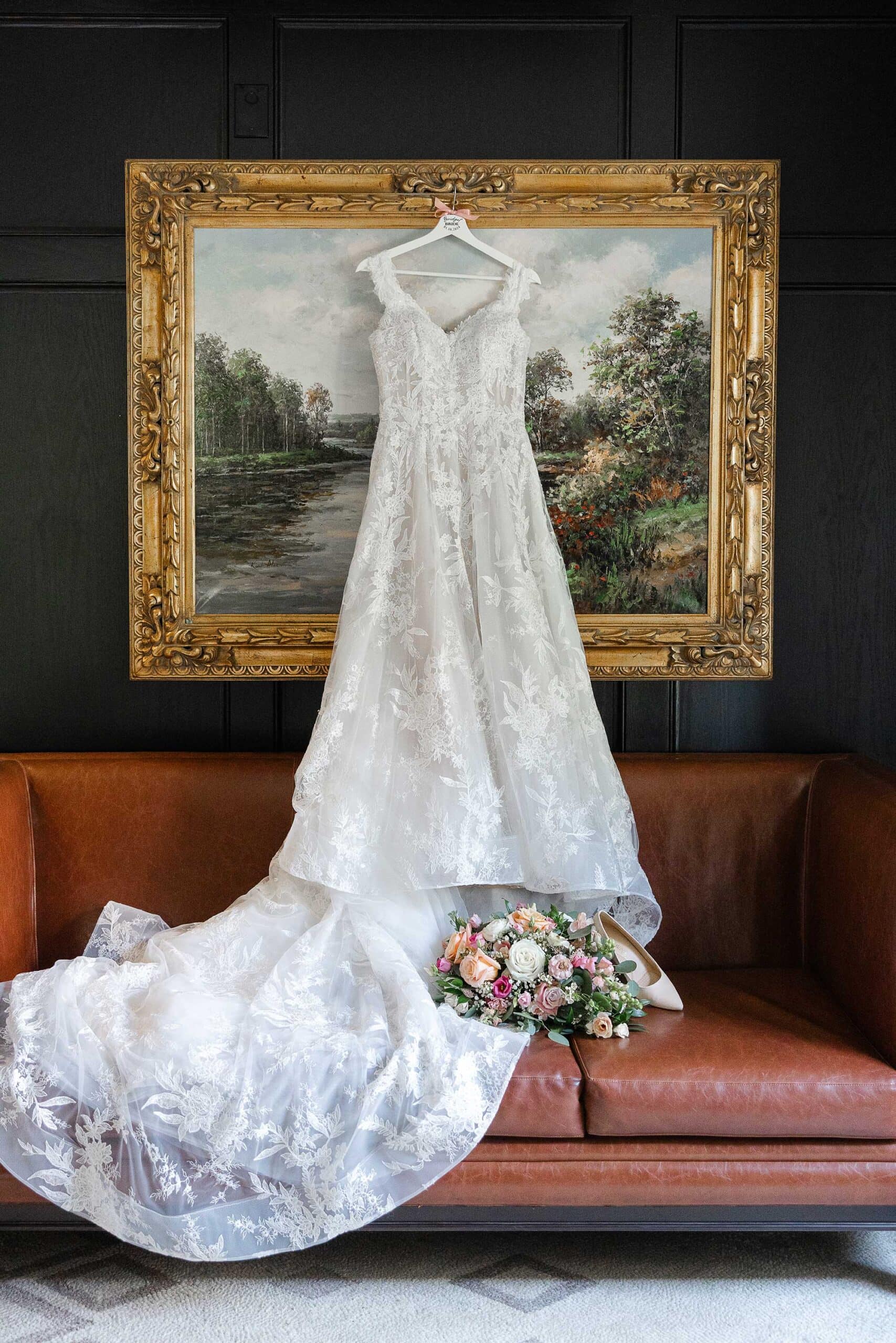 McMann-GettingReadyPhoto-by-Penny-Ralene - The dress, bouquet and bride's shoes are displayed.