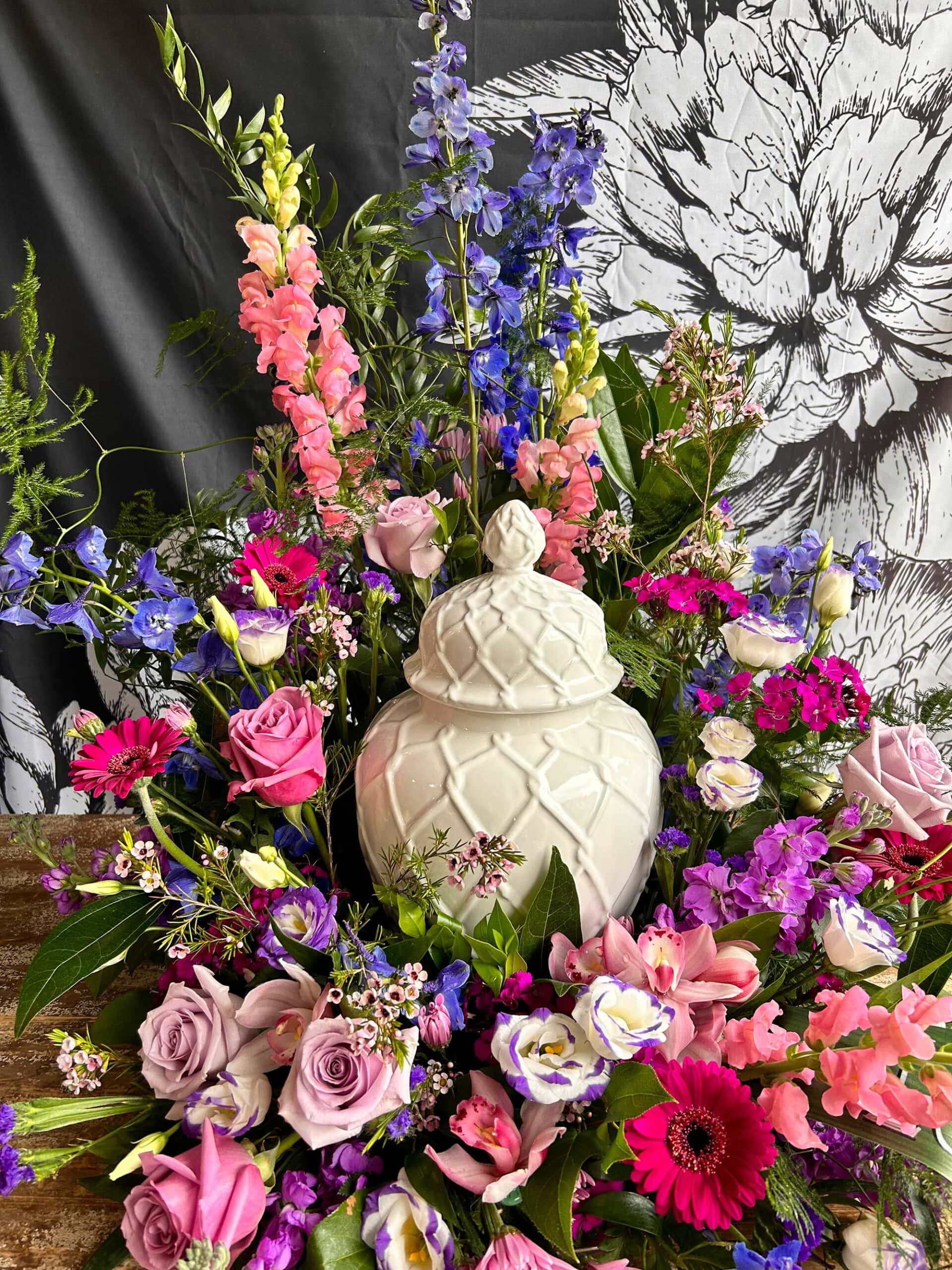 Urn Surrounded in Pinks, Purples and Blue florals An urn surrounded by florals from Art in Bloom Floral Studio in Howell, Michigan.