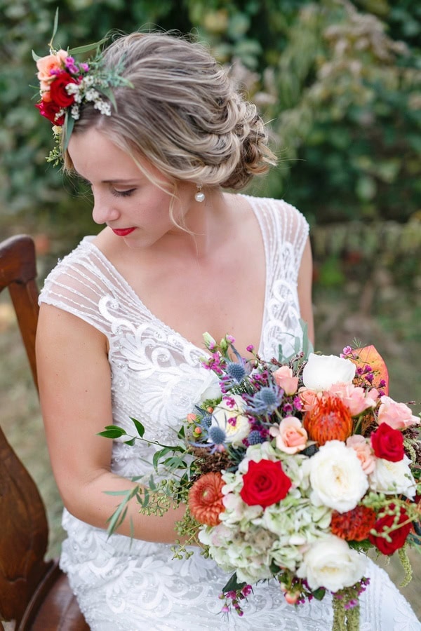 A bride with her bouquet and hair piece by Art in Bloom Floral Studio. Photo by Lia Gianotti Photography.
